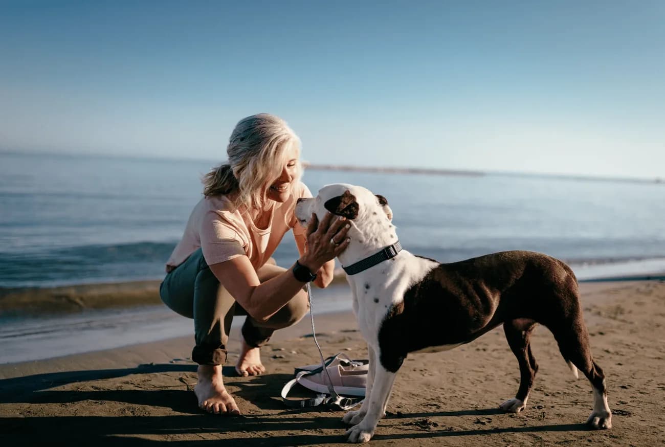 Woman with her dog on the beach